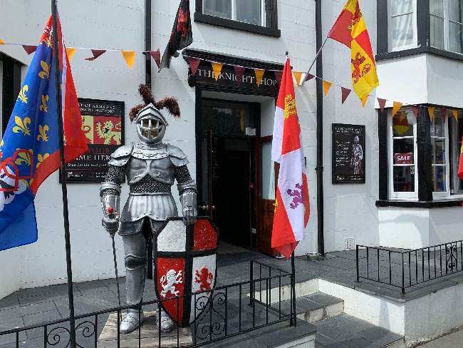 The shop entrance outside with knight statue